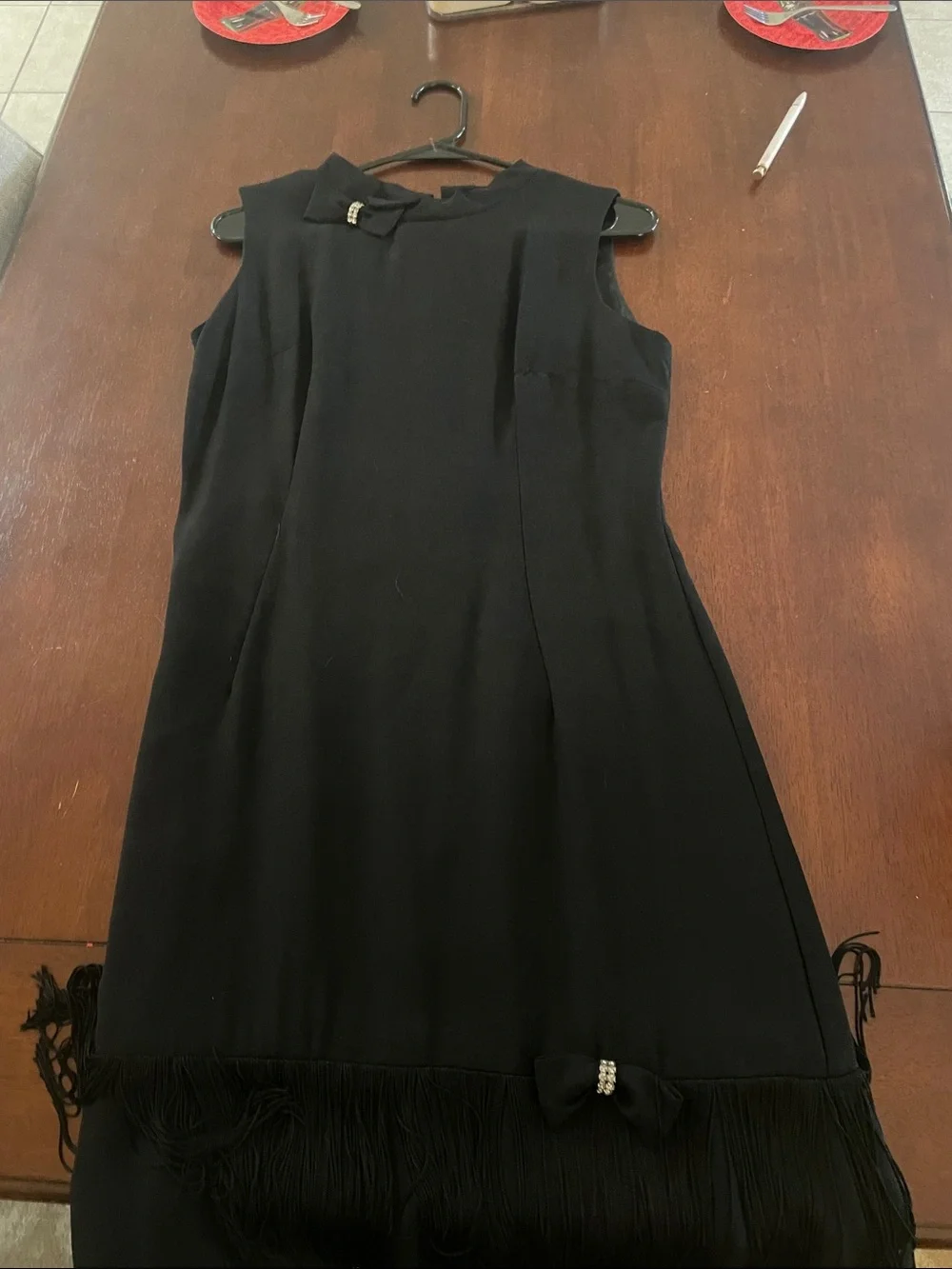 Elegant Black Sleeveless Midi Dress with Bow & Fringe Detail